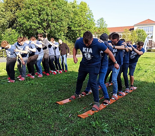 Students play on a meadow on campus.