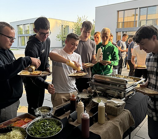 Students help themselves at the buffet on campus.